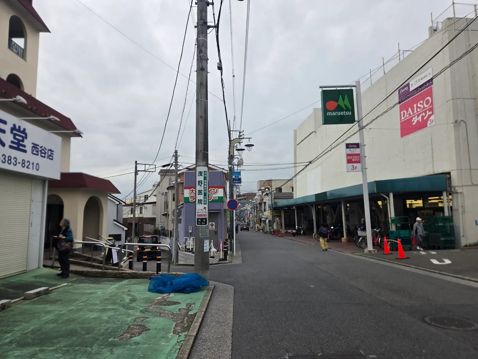 西谷駅近くのマルエツ 西谷店の外観。3階にダイソーとカーブスが入り、店の脇に通りが続いている